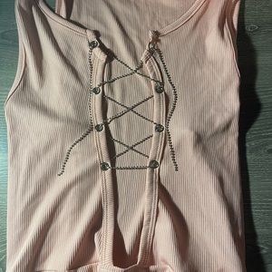 Light pink body suit.